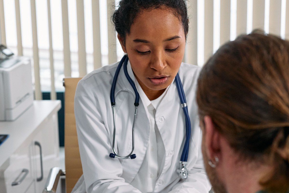 Doctor consulting patient in clinical setting
